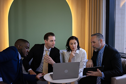 Colleagues discuss SMB cybersecurity. 