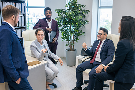 Colleagues discuss SMB cybersecurity. 